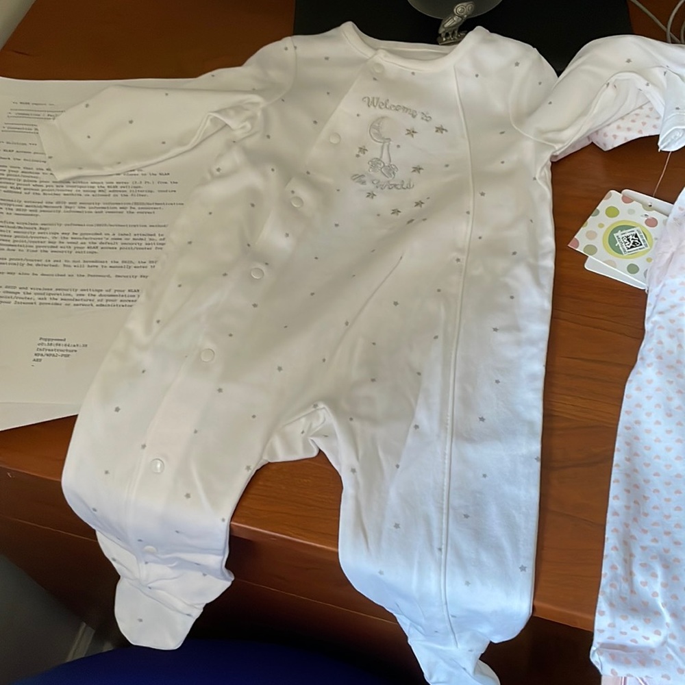 4 little me NWT 6 month footie onsies with matching hats.